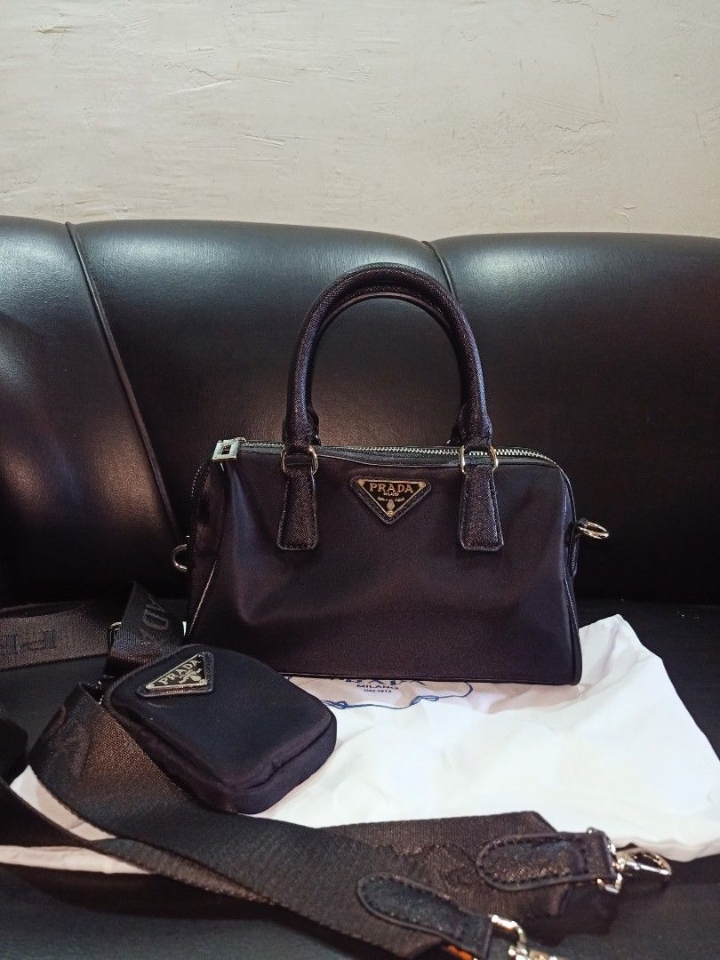 Preloved prada two- way bag small (Category: Luxury Bags & Wallets) located in Cebu City. Submitted by day.98 (Listing ID 1199437669, Image 1). Description: from japan surplus small size nylon type & saffiano leather no flaws coded lampo zipper.