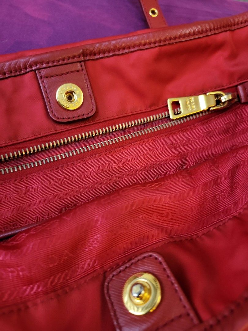 Prada Tessuto Saffiano Nylon Tote (Category: Luxury Bags & Wallets) located in Mandaluyong City. Submitted by autumndei (Listing ID 1194583130, Image 3). Description: authentic no card red color with bag tag clean interior gold hardware please refer to pics- light scuffings on the handle no return/ exchange or refund Origin: Italy Measurements: 14” L x 5.75” w x 12.5” H Interior Pockets: One zip pocket, one flat pocket Handles: Double flat leathe