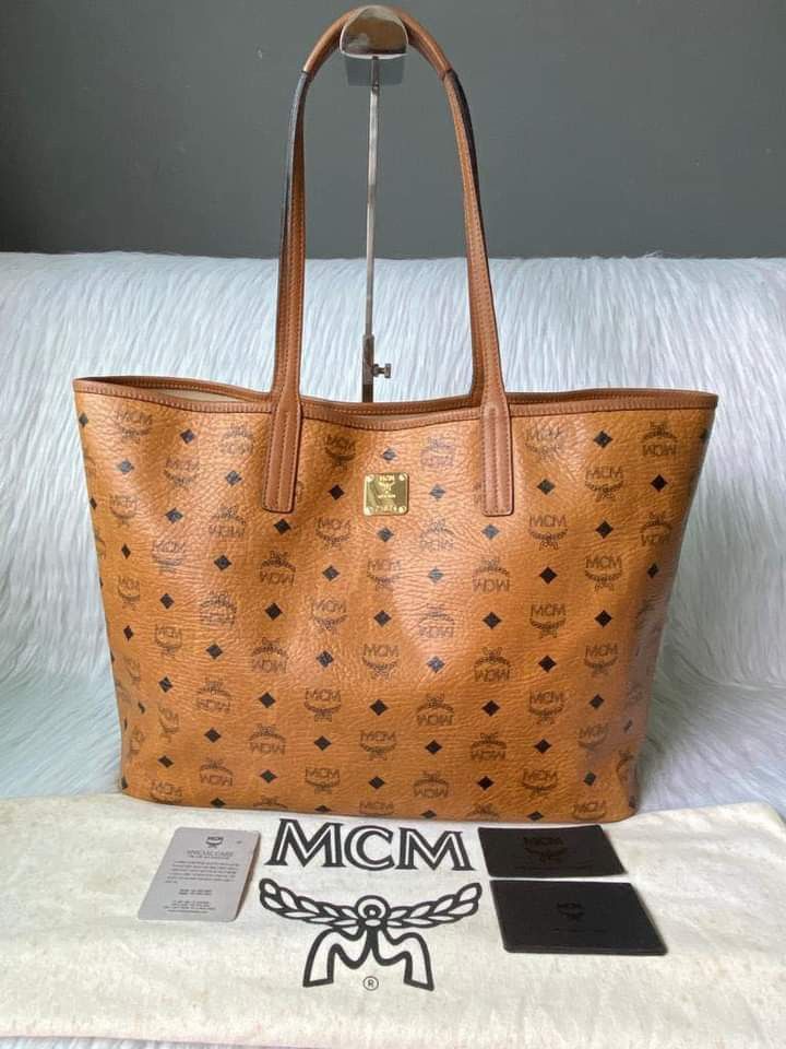 MCM Cognac Tote Bag MM (Category: Luxury Bags & Wallets) located in Manila. Submitted by bagislifeshop (Listing ID 1195041066, Image 1). Description: ▪️MCM Cognac Tote Bag MM▪️ ☑️Available in Manila ✅Condition: 8.8/10 ✅Material: coated canvas leather ✅Inclusions: dust bag and cards.