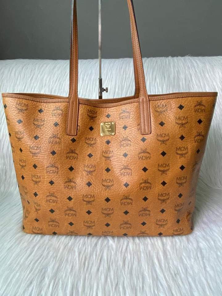 MCM Cognac Tote Bag MM (Category: Luxury Bags & Wallets) located in Manila. Submitted by bagislifeshop (Listing ID 1195041066, Image 2). Description: ▪️MCM Cognac Tote Bag MM▪️ ☑️Available in Manila ✅Condition: 8.8/10 ✅Material: coated canvas leather ✅Inclusions: dust bag and cards.