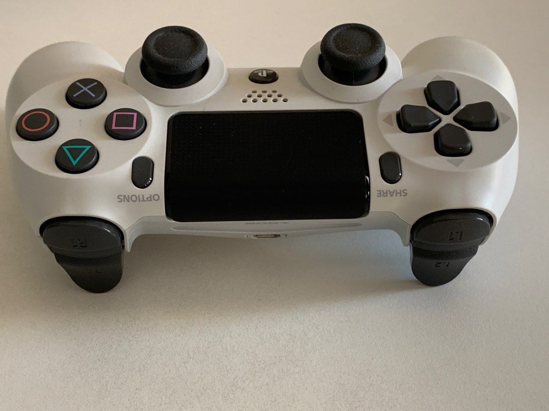 PS4 Controller (Category: Controllers) located in Singapore. Submitted by lee.weisong.7 (Listing ID 1194960798, Image 3). Description: 9.9/10 condition. White in colour. Only without the charging cable. For PS4. .