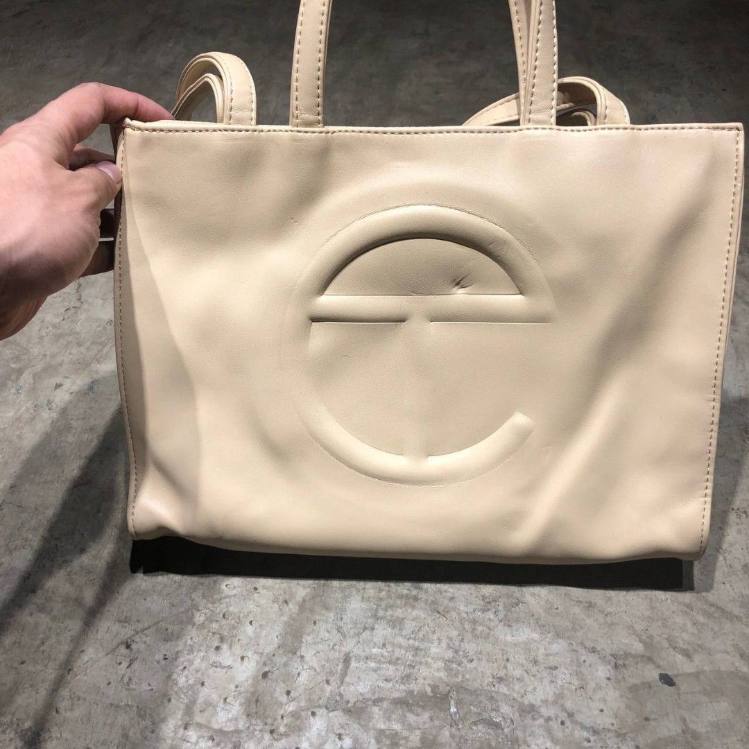 Telfar Shopping tote bag (Category: Luxury Bags & Wallets) located in Quezon City. Submitted by johnpaulperezzz (Listing ID 1194987359, Image 2). Description: Telfar Shopping Tote Bag material: Leather size: Medium dimension: Width: 12.5" Length: 9" condition: 8.5/10 issue: - small yellow dirt at the handle - small dent at the front bag Retail: $500 Price: 10k.