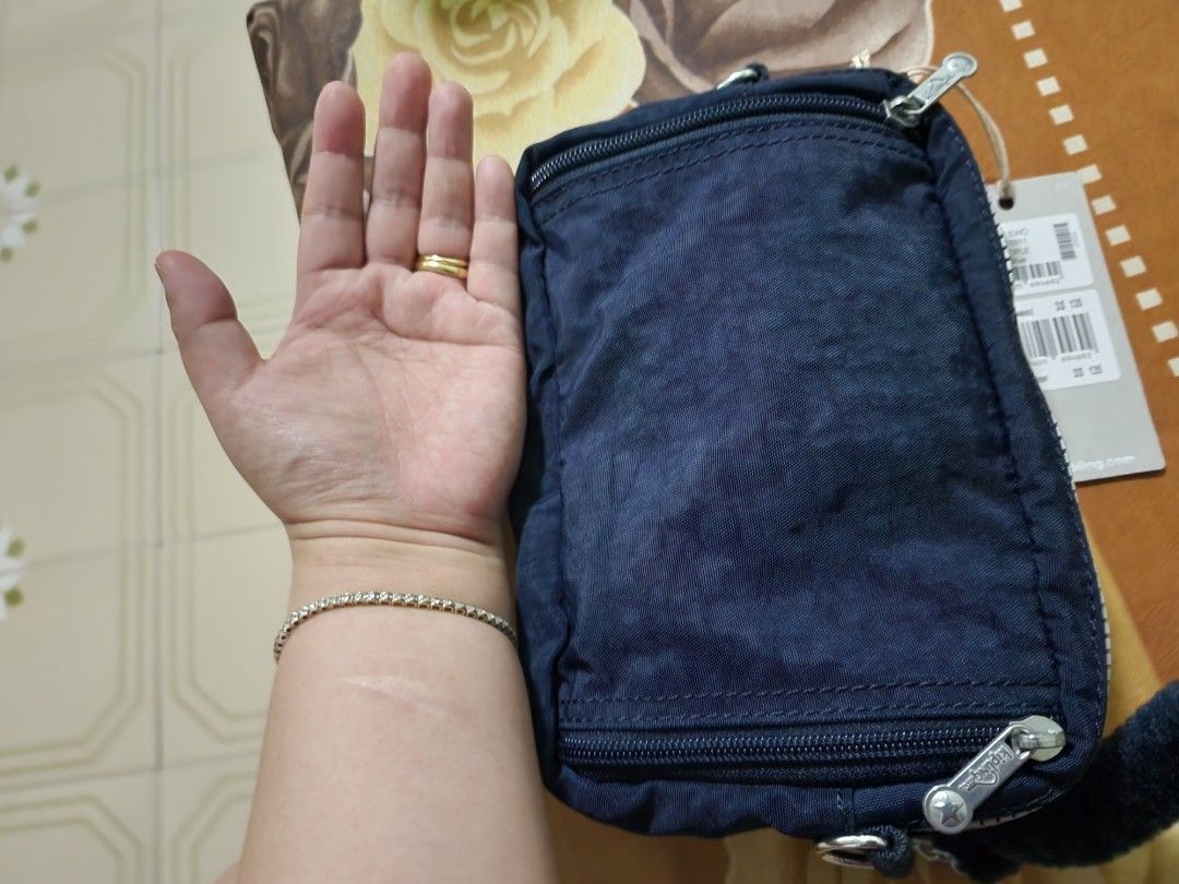 Kipling (Category: Purses & Pouches) located in Singapore. Submitted by black_cat1985 (Listing ID 1193900589, Image 3). Description: too small for me, convertible from waist bag to sling W19.5cm X H12.5cm X D7 look at the photos and guage the size yourself please.