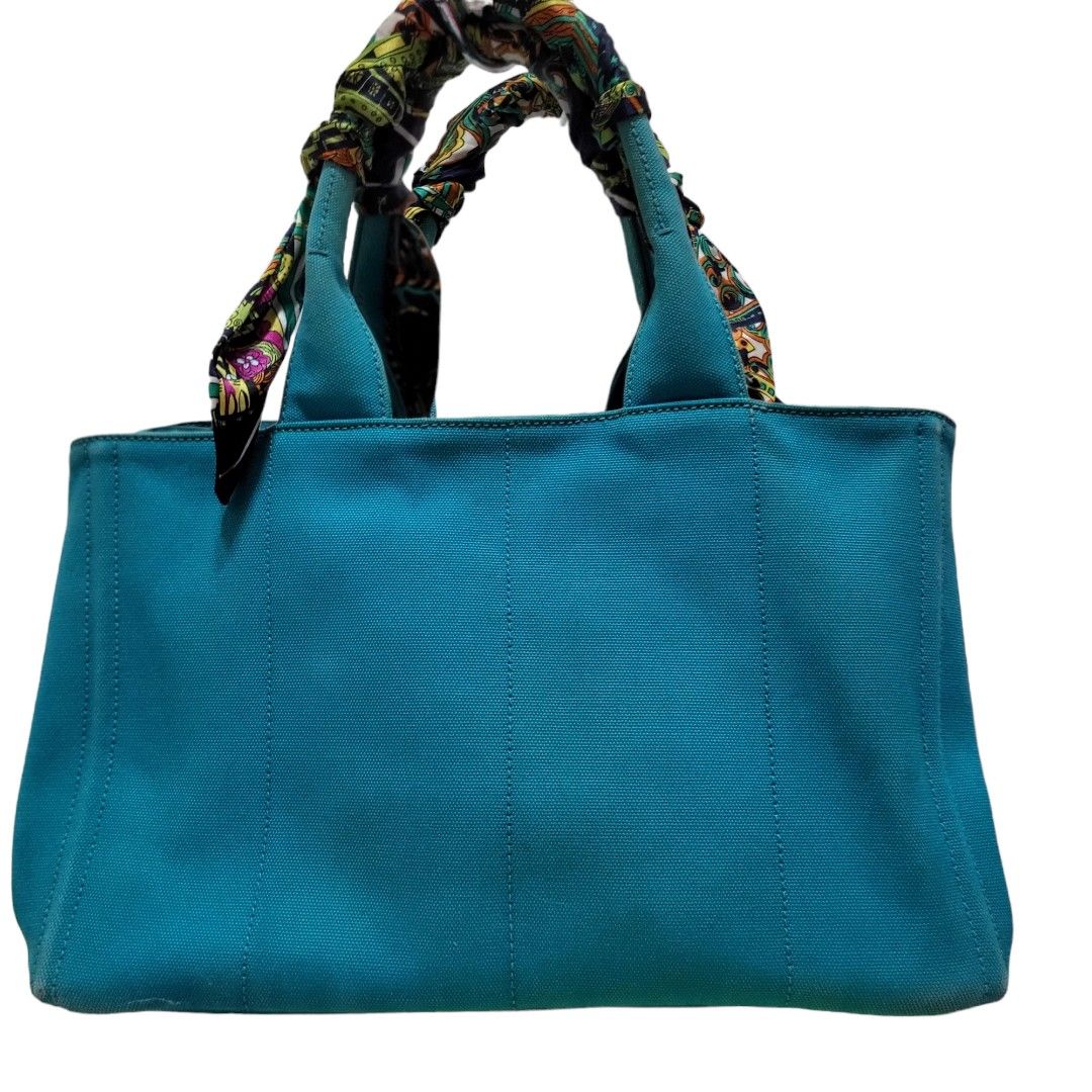 Authentic Prada Canapa Tote (Category: Luxury Bags & Wallets) located in Quezon City. Submitted by brand_bargains (Listing ID 1195407195, Image 2). Description: Guaranteed Authentic Large size No strap included Bag only Handles are faded but can be covered with a bag twilly as shown in the photos Still in a very good condition..