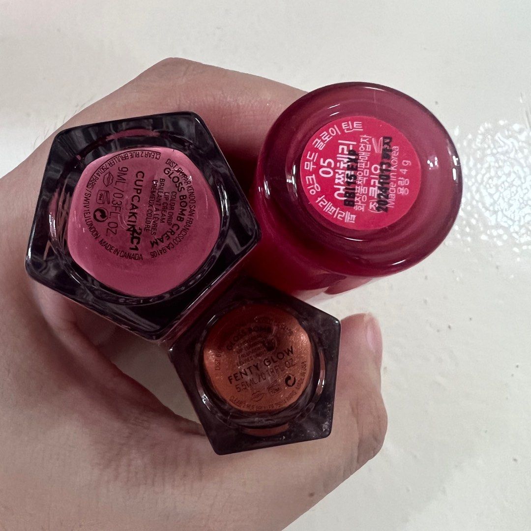 Fenty Beauty Gloss x Peripera (Category: Makeup) located in Paranaque City. Submitted by chinitamaria (Listing ID 1200259555, Image 3). Description: Set of 3 na po makukuha nyo for almost a price of 1 fenty gloss. - fenty gloss bomb cream shade: cupcakin’ - fenty gloss lumi shade: fenty glow mini size and may konti discoloration sa cap - peripera ink mood tint shade: cherry so what -brandnew po yung 3 but all swatched once lang. - yung 2 fenty wa