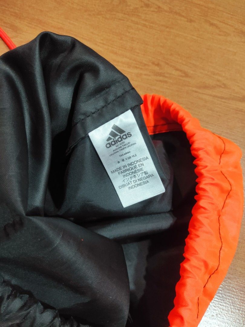 Authentic Adidas Draw String Bag (Orange and Black) (Category: Backpacks) located in Makati City. Submitted by lishey (Listing ID 1202224505, Image 3). Description: Authentic Adidas Drawstring Bag (Black and Orange) RFS: Decluttering Mode of Payment: Gcash or BPI Delivery can be made through Grab or Lalamove Shipping/Delivery fee is shouldered by the buyer.