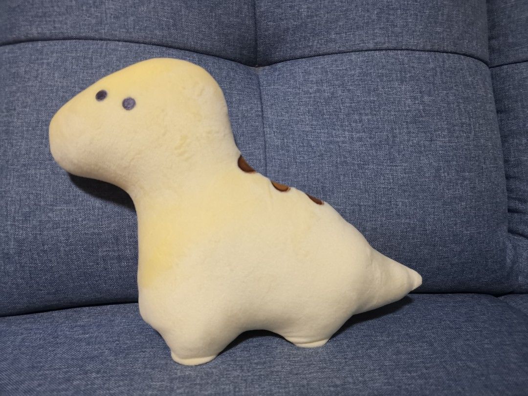 yellow stuffed dinosaur