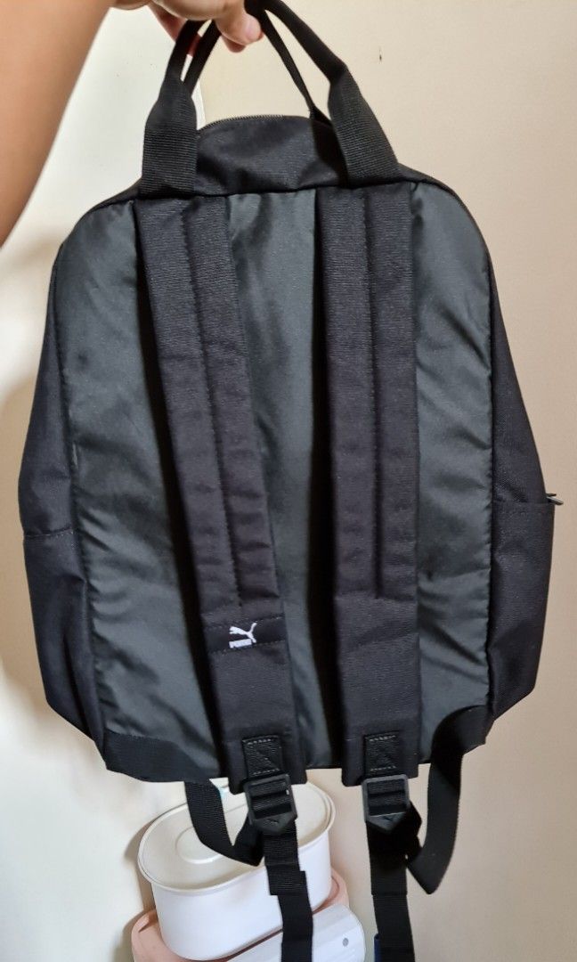 Puma Urban Tote Backpack (Category: Backpacks) located in Paranaque City. Submitted by patlalu_shop (Listing ID 1202780338, Image 2). Description: Brand New (only removed from plastic) Original price:₱2,500 RFS: wrong purchase DETAILS: -Two-way zip opening into main compartment -Large zip pocket at front - Slip-in pocket at side -Fabric laptop compartment inside - Webbing carrying handles on top with handle connector - Adjustable and padded shoul