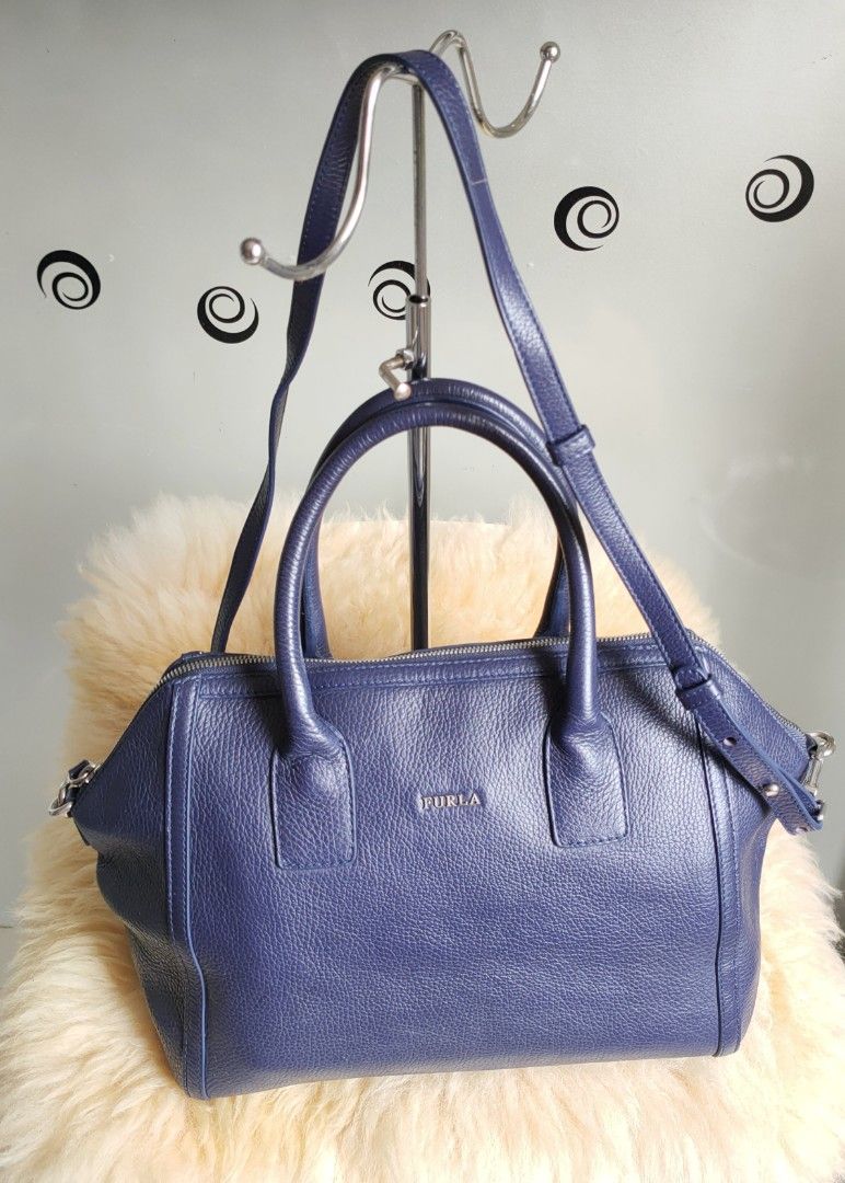 FURLA Satchel/ Top Handle Bag (Category: Luxury Bags & Wallets) located in Tuguegarao City. Submitted by roab_ (Listing ID 1202935880, Image 2). Description: Color: Blue Material: Pebbled leather/ silver tone hardware 🔸 Top zip closure 🔸 Double wrapped leather handles and shoulder strap with a 38 inches long strap. 🔸 Dimensions: 16"L (across top) 12"L (across bottom) X 9.5"H X 6"W. 🔸 Last price posted. 🔸 I ship fast. 🔸Shipping/delivery fee 