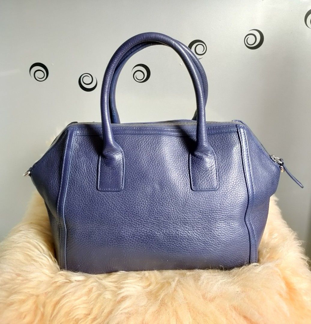 FURLA Satchel/ Top Handle Bag (Category: Luxury Bags & Wallets) located in Tuguegarao City. Submitted by roab_ (Listing ID 1202935880, Image 3). Description: Color: Blue Material: Pebbled leather/ silver tone hardware 🔸 Top zip closure 🔸 Double wrapped leather handles and shoulder strap with a 38 inches long strap. 🔸 Dimensions: 16"L (across top) 12"L (across bottom) X 9.5"H X 6"W. 🔸 Last price posted. 🔸 I ship fast. 🔸Shipping/delivery fee 