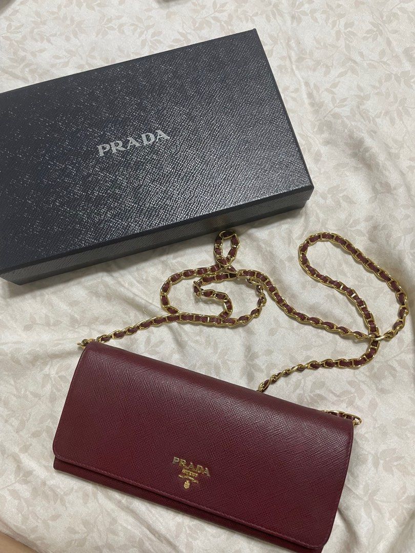 Prada Saffiano Wallet on Chain (Category: Luxury Bags & Wallets) located in Quezon City. Submitted by wardrobebykeith (Listing ID 1203017288, Image 1). Description: Prada Saffiano WOC in Cerise (Maroon) Condition: 7.5/10 Flaw: “P” in Prada is a bit faded but not that apparent Complete with care card and box.