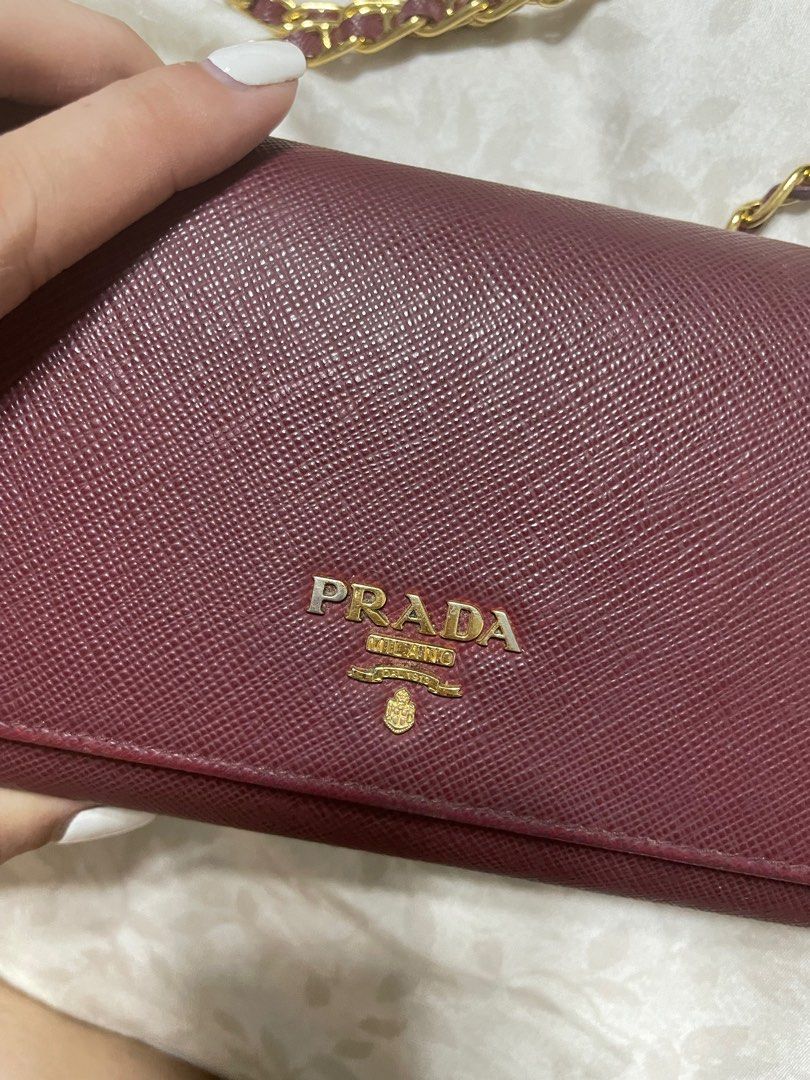 Prada Saffiano Wallet on Chain (Category: Luxury Bags & Wallets) located in Quezon City. Submitted by wardrobebykeith (Listing ID 1203017288, Image 3). Description: Prada Saffiano WOC in Cerise (Maroon) Condition: 7.5/10 Flaw: “P” in Prada is a bit faded but not that apparent Complete with care card and box.