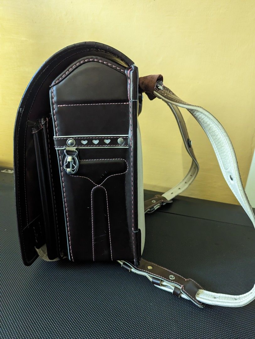Randoseru for girls (Category: Backpacks) located in Binan City. Submitted by silvercrystal.a0d726 (Listing ID 1203313261, Image 2). Description: Girl's randoseru. Brown with pink stitching and interior. Made in Japan. 9/10 condition. With minor flaw- zipper tab.