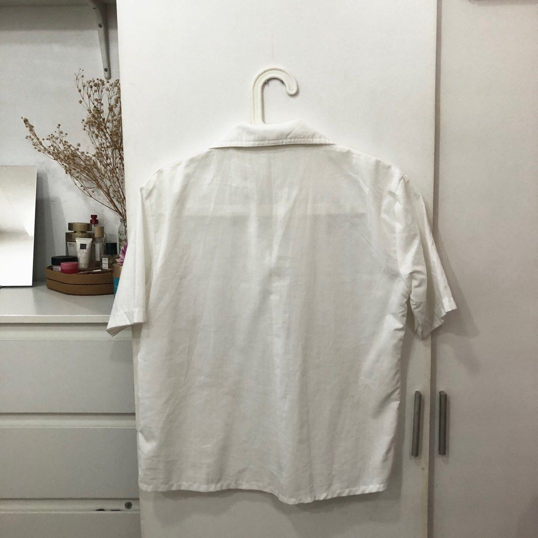 White Buttoned Blouse (Category: Blouses) located in Marikina City. Submitted by declutterbymilkee (Listing ID 1203438106, Image 3). Description: White Buttoned Blouse with Mini Patterns - material is light & kind of see through - the patterned patches along the buttons are so cute! - if you like oversized clothes, this is for you - can fit M-L Payment: Gcash/ Maya SF not included Ref. #4.