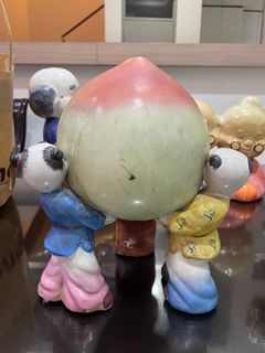 8” Porcelain peach with 3 chinese boys holding it