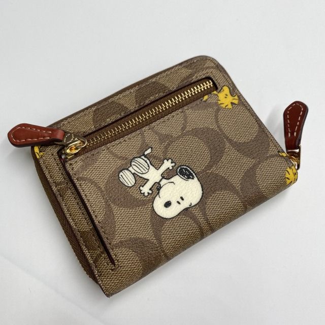 COACH®  Coach X Peanuts Round Coin Case In Signature Canvas With Snoopy  Presents Print