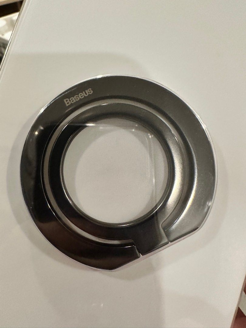 BASEUS: Foldable Metal Ring Stand (Category: Mounts & Holders) located in Manila. Submitted by rmgcloset (Listing ID 1204068103, Image 2). Description: Bought this for 539 pesos. Used for only 1 month with some minor scratches in the item but negligible from afar. No problems with the magnet. Box still intact and with the free magnet sticker for phone with no Magsafe features. RFS: using a new ring mount Buyer will shoulder delivery fee..