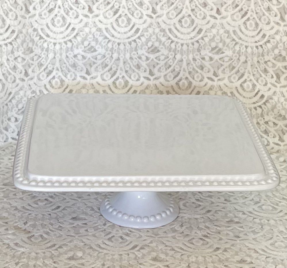 Embossed Square Ceramic Cake Stand (Category: Bakeware) located in Paranaque City. Submitted by vintagesoulmanila (Listing ID 1204285158, Image 1). Description: Measurements: *Diameter - 11 inches *Height - 4.5 inches.
