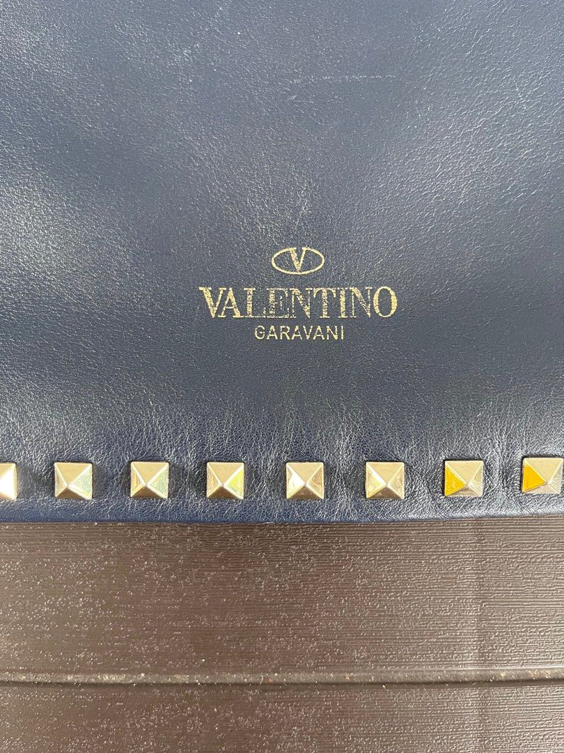 Pre-Loved Valentino Rockstud Clutch (Category: Luxury Bags & Wallets) located in Makati City. Submitted by the_ambitious_peasant (Listing ID 1204315710, Image 2). Description: Bought this bag pre-loved from a reputable seller. Comes as bag only but with Entrupy certification (see last photo) What you should know: Bag has some scratches on the leather but is very tolerable in person. Looks better in person too..