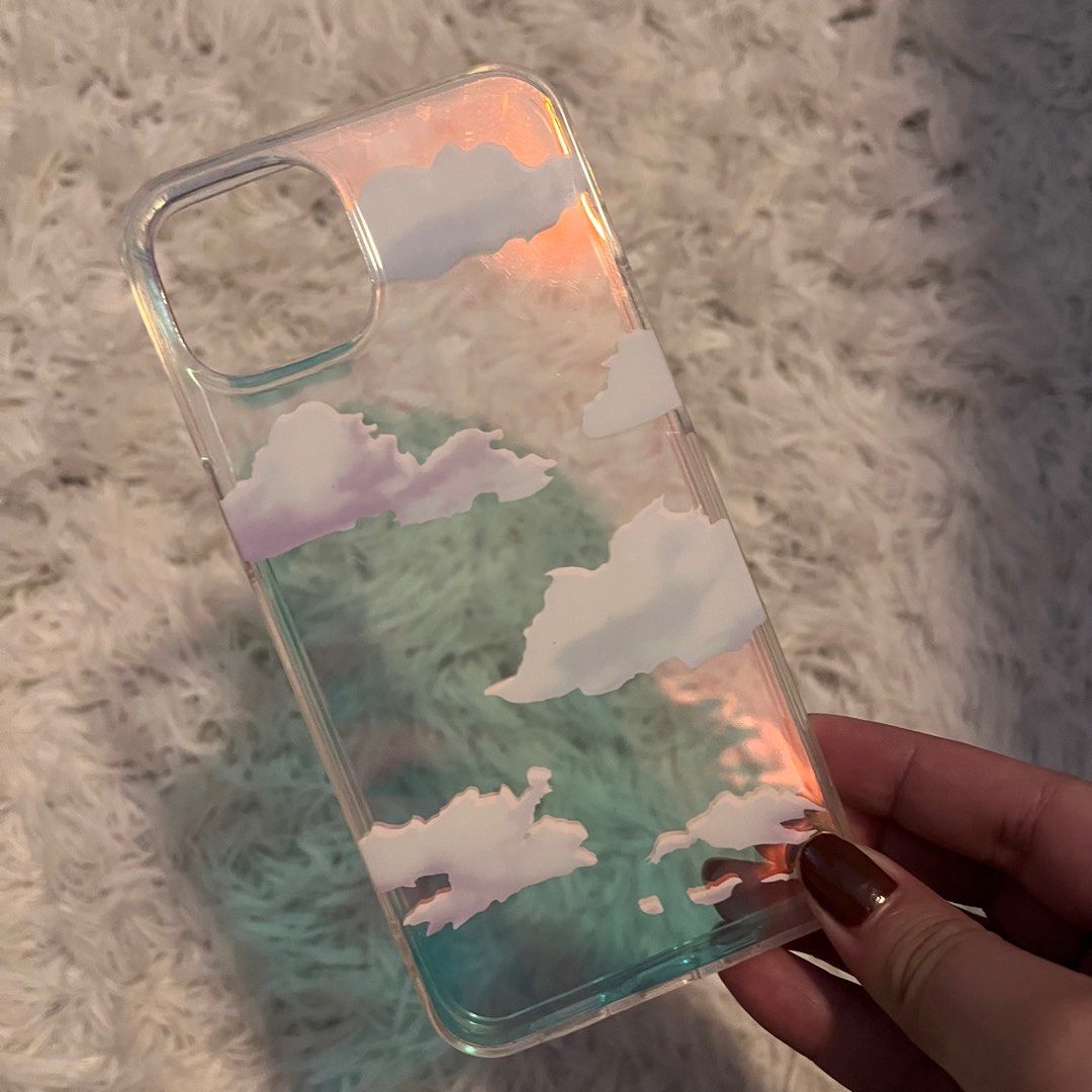 Holographic Clouds iPhone 13 Case (Category: Cases & Sleeves) located in Las Pinas. Submitted by gabskkasells (Listing ID 1205393275, Image 1). Description: This case is so cute and I love that the clouds are actually high quality printed and not cheaply pixelated ☁️ • RFS: Bought new cases and don't really see myself using this one anymore • Only used for a short while (aka like less than a week).