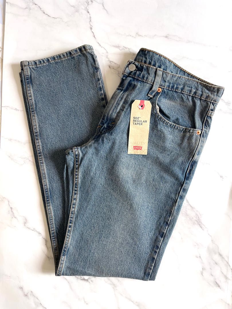 Levi's Men's 502 Taper jeans medium blue size 32x34, Men's Fashion,  Bottoms, Jeans on Carousell