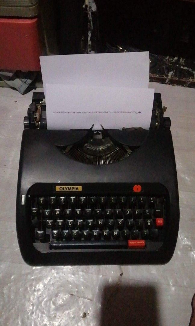 F/S: Black Olympia Typewriter (Vintage ) (Category: Office & Business Technology) located in Bacoor. Submitted by piolo16 (Listing ID 1205964978, Image 1). Description: For Sale: VINTAGE OLYMPIA Typewriter Price: 3.5k ✔️ All Keys are Working ✔️ In Good Condition ✔️ Cover ✔️ Ink/Ribbon ✔️ Ready to Used ✔️ Cash on Pickup via LBC ✔️ Cash on Delivery via LALAMOVE ✔️ Bacoor Area ✔️.