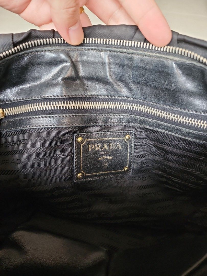 Prada Tessuto Gaufre Nero (Category: Bags & Wallets) located in Singapore. Submitted by jtan1981s3 (Listing ID 1206188519, Image 3). Description: 100% Authentic comes with Dust bag and receipt. alot of loose threads and need cleaning.Going at this low price because: the internal zipper pocket is torn. gold hardware had degraded. torn at the handle..