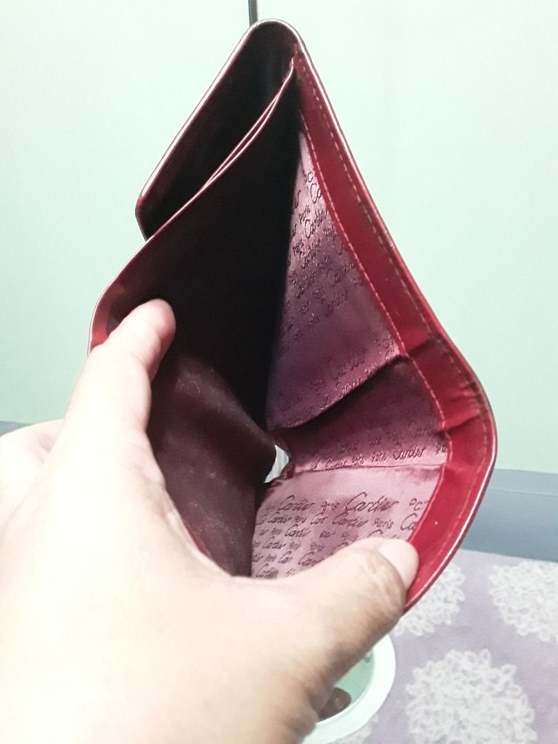 Cartier medium wallet (Category: Luxury Bags & Wallets) located in Daanbantayan. Submitted by christinet58475 (Listing ID 1200796314, Image 2). Description: Cartier trifold medium wallet in burgundy color. Some rubs on the corners and edges but it's very minimal. Normal signs of usage as this is already used. Cartier brand is embroidered on the linings. 8/10 condition. .