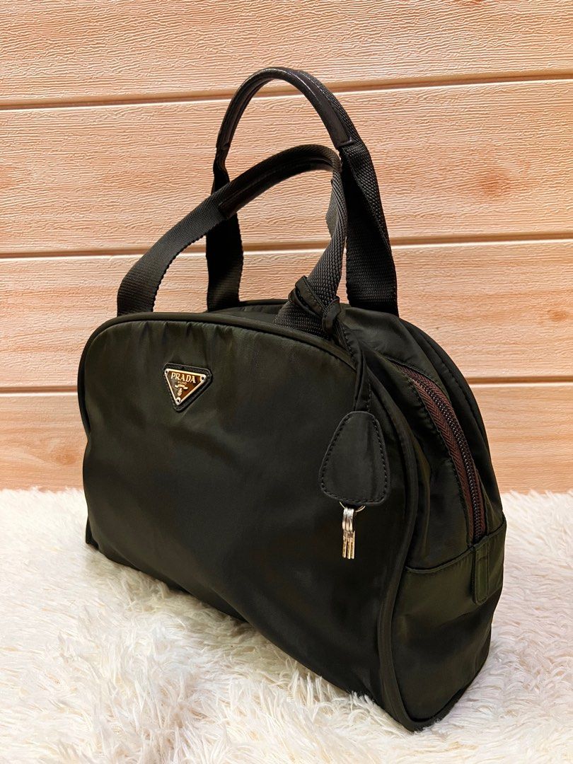 Authentic Prada Bowlers Bag (Category: Luxury Bags & Wallets) located in Cagayan de Oro. Submitted by riggstuffs (Listing ID 1201981528, Image 3). Description: Guaranteed Authentic Prada Bowlers Bag Made in Italy With white code Exterior is made of nylon material complimented with leather trimming Interior is clean and spacious With lock and key DISCLAIMER: Riggstuffs is not affiliated or associated with the brand posted. All trademarks and copyr
