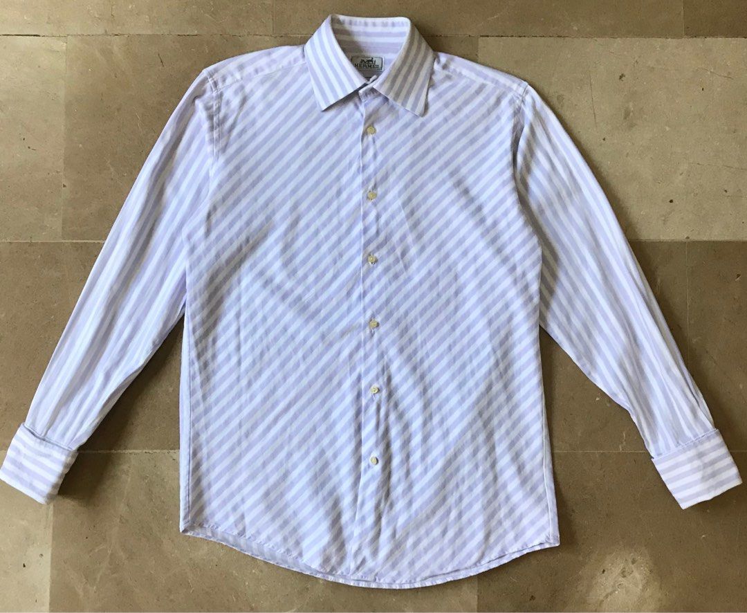 Hermes bias shirt (Category: Luxury Apparel) located in Quezon City. Submitted by raccoonfur (Listing ID 1201986775, Image 1). Description: Special mid-weight weave cotton poplin shirt. Subtle texture to go with its striped pattern. French cuffs with Chinoiserie cufflinks. And an interesting bias cut front panel. Very good condition. Pit to pit 22” Length 29.5” Inseam 21” Shoulders 18.5” .