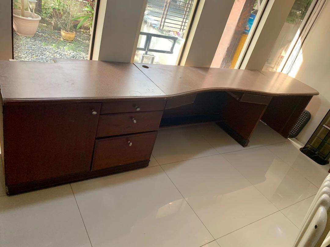 Long Executive Desk / Office Table (Category: Office Furniture & Fixtures) located in Quezon City. Submitted by jmariekondo (Listing ID 1142780202, Image 3). Description: Used long executive desk (approx. 3.5m wide) Dimensions: 350cmx50cmx75cm w/ Built-in drawers and cabinet Missing keyboard tray Scratches from regular use (easily retouched) Rfs: decluttering QC West ave pickup.