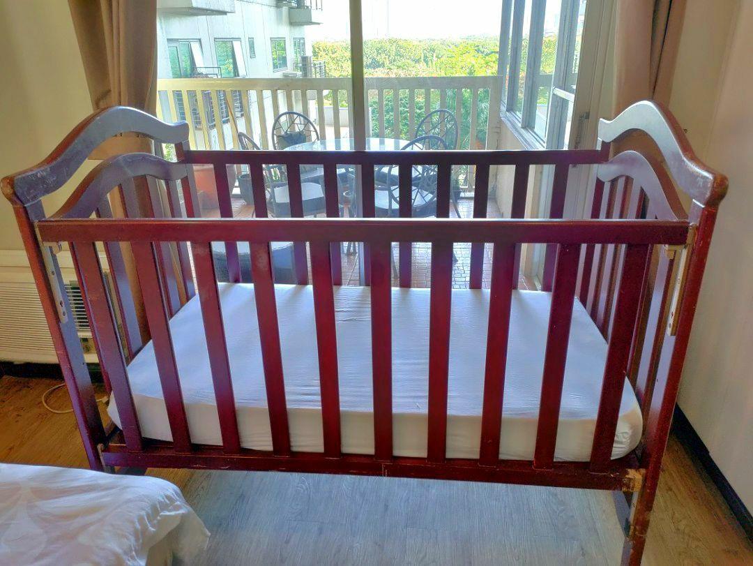 solid wood drop crib with free spring mattress and crib mobile on Carousell