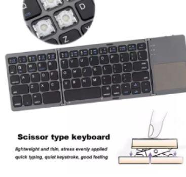 Portable Mini Ultra Slim Foldable BT Wireless Keyboard with Touchpad (Category: Computer Keyboard) located in Marikina City. Submitted by skowshop (Listing ID 1143260183, Image 2). Description: Compatible with: iPhone 6s/iPad Pro/MacBook Mobile Phone Tablet PC Features: > ingenious folding design beautiful and practical > wireless BT 3.0 fast pairing and wide operating range > 64-key layout with multi-function keys compact and excellent > scissor
