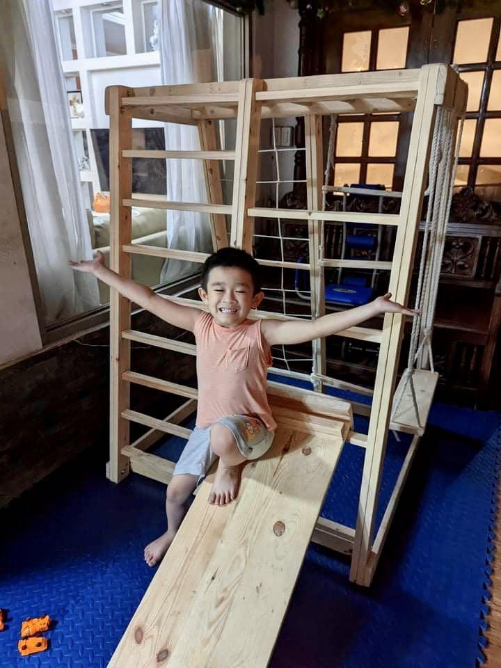 Jungle gym/play gym (Category: Other Kids Furniture) located in Mandaluyong City. Submitted by jenwoodworks (Listing ID 1143743605, Image 3). Description: Our jungle gym: indoor/outdoor play gym 😍 This is the real deal as you get all of the following in 1 montessori toy! - monkey bar - military climber - bar ladder - swing - rock wall climbing - slide - hanging ladder - instant playhouse - hammock (by request/additional fee) - easy assemble Ramp