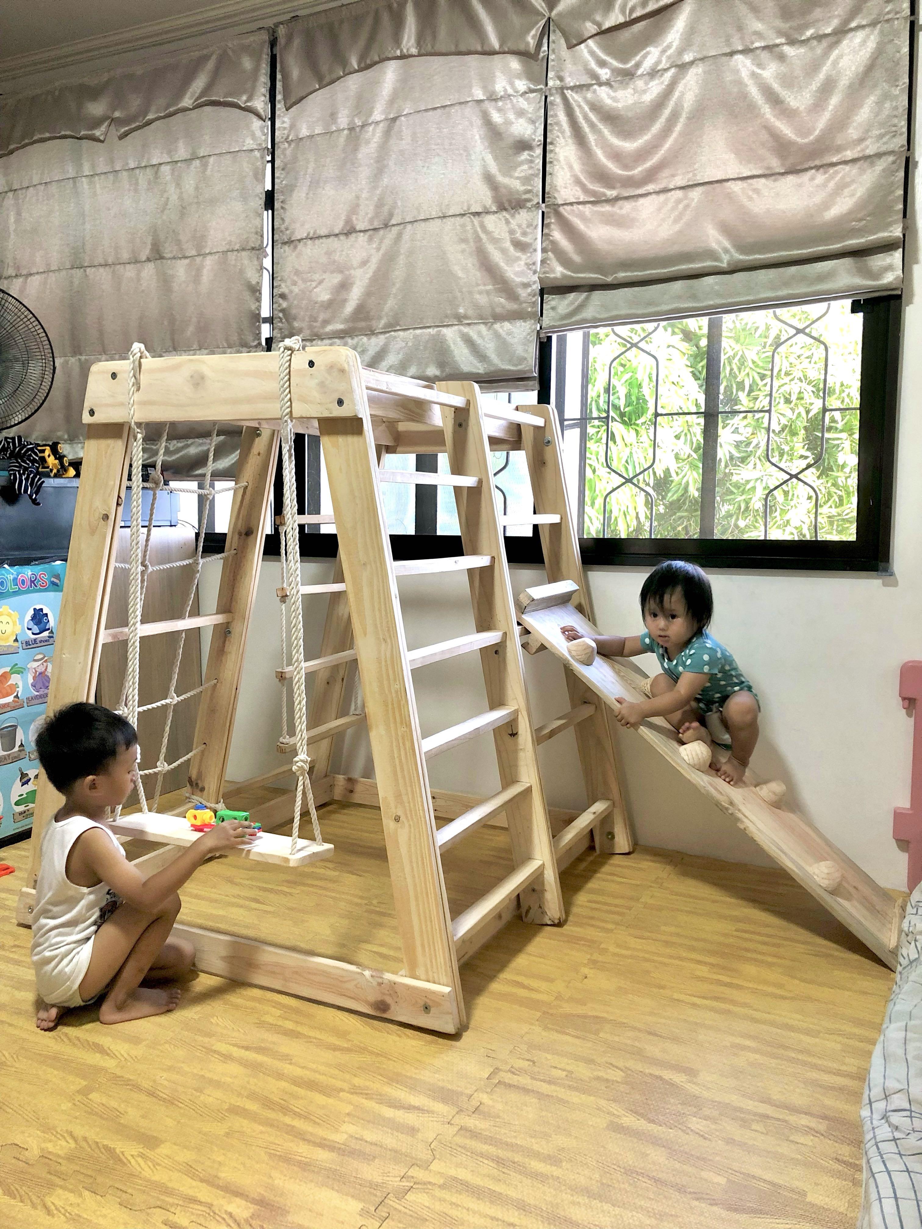Jungle gym/play gym (Category: Other Kids Furniture) located in Mandaluyong City. Submitted by jenwoodworks (Listing ID 1143743605, Image 1). Description: Our jungle gym: indoor/outdoor play gym 😍 This is the real deal as you get all of the following in 1 montessori toy! - monkey bar - military climber - bar ladder - swing - rock wall climbing - slide - hanging ladder - instant playhouse - hammock (by request/additional fee) - easy assemble Ramp