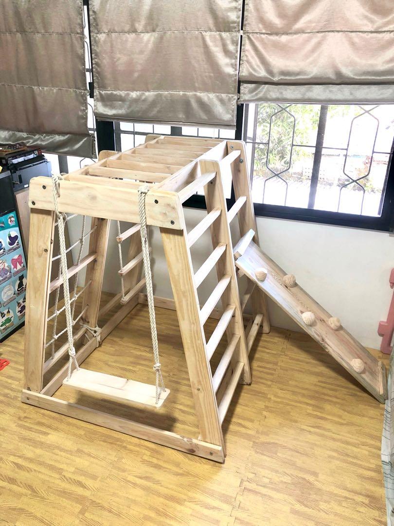 Jungle gym/play gym (Category: Other Kids Furniture) located in Mandaluyong City. Submitted by jenwoodworks (Listing ID 1143743605, Image 2). Description: Our jungle gym: indoor/outdoor play gym 😍 This is the real deal as you get all of the following in 1 montessori toy! - monkey bar - military climber - bar ladder - swing - rock wall climbing - slide - hanging ladder - instant playhouse - hammock (by request/additional fee) - easy assemble Ramp
