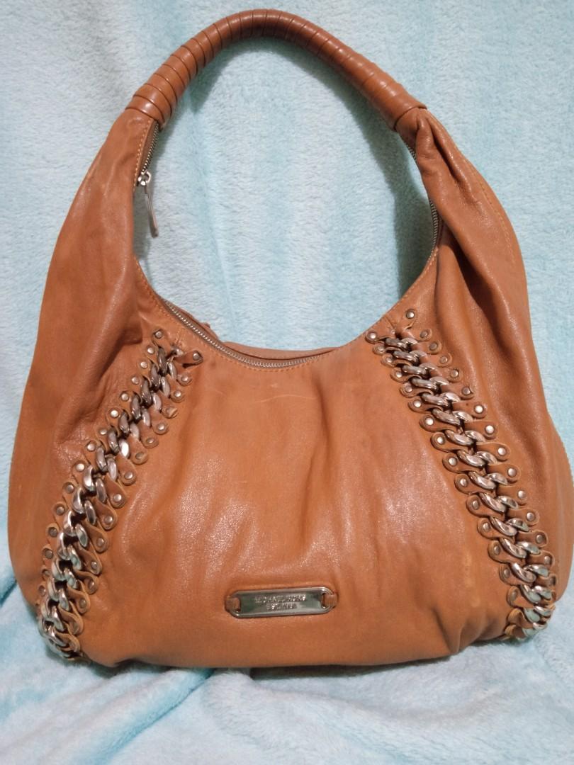 Michael Kors Hobo Bag (Category: Luxury Bags & Wallets) located in Rizal. Submitted by allaboutbeautythings (Listing ID 1146301209, Image 1). Description: Original Preloved Michael Kors Flaw: please see pictures. oxidation on handle, some fading Color: Brown.