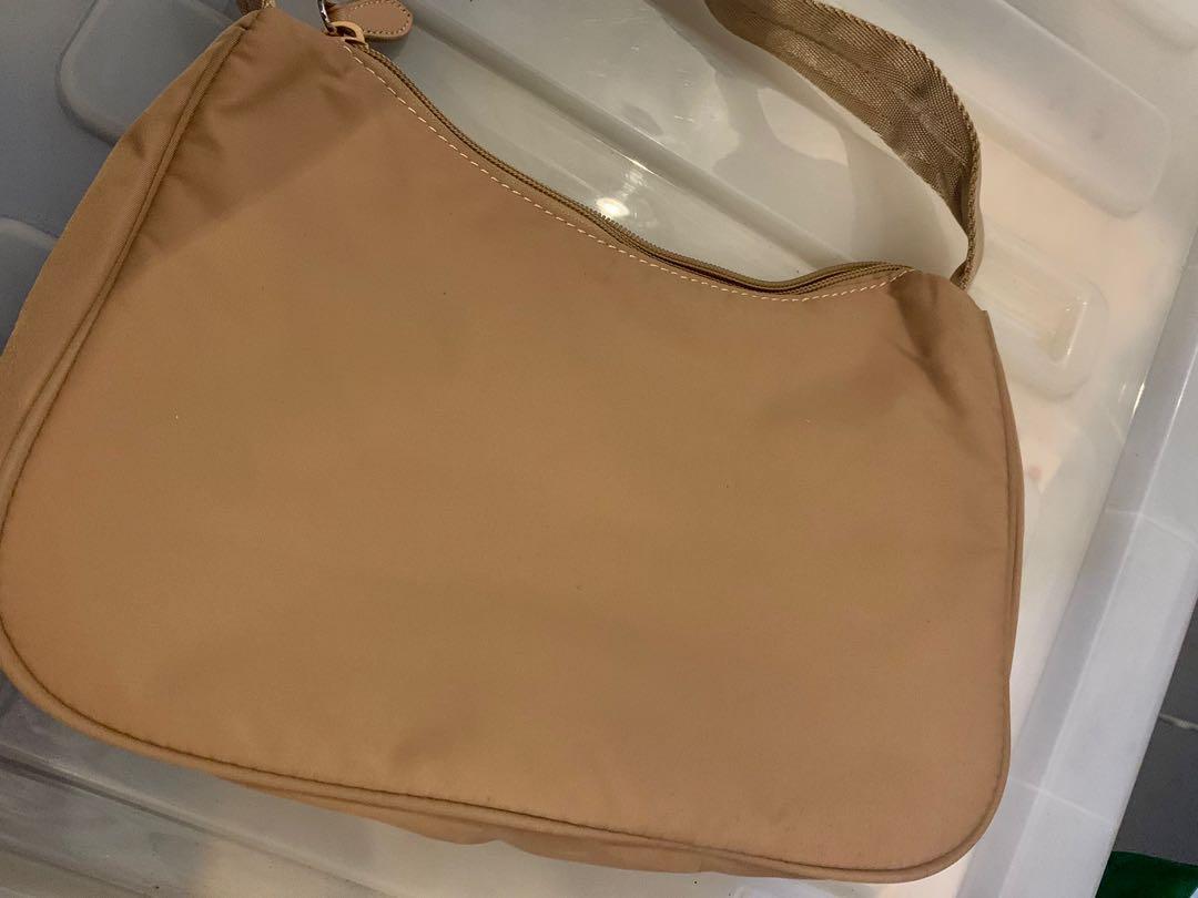 Vintage Prada Baguette Bag (Category: Luxury Bags & Wallets) located in Mandaluyong City. Submitted by amvvg (Listing ID 1142011742, Image 2). Description: Vintage Prada Baguette Bag Lampo zipper NGA - Please self authenticate before purchasing All pictures posted Issue: with hole inside - no code (see last pic) Selling for only 4,500 Rfs: Decluttering For pickup in Mandaluyong area.