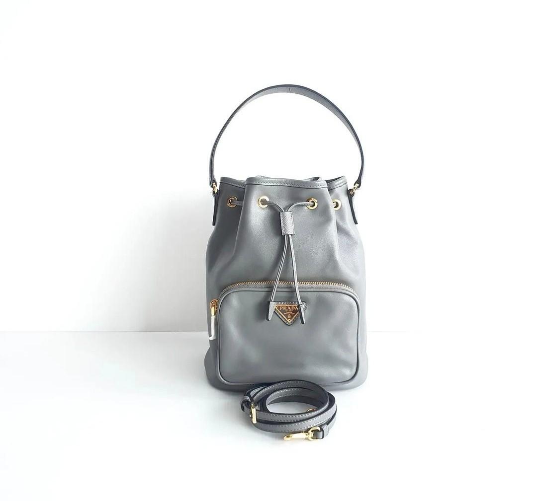 Prada Grey Leather Gold Hardware Drawstring Bucket Bag 1BH038, Luxury, Bags  & Wallets on Carousell