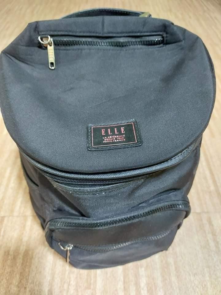 ELLE Fashion Backpack (Category: Backpacks) located in Antipolo. Submitted by kdens21 (Listing ID 1149670564, Image 1). Description: ELLE Fashionable Backpack Original price when bought: Php 1,300 Size: 14.5in x 12in; allowed as one piece carry-on baggage in airplanes -water resistant and interior padded -interior: 2 open pockets, 1 zipped pocket -exterior: one main bag zipper, 5 additional pockets (3 zipped pockets, 2 magnetic buttons) -if you w