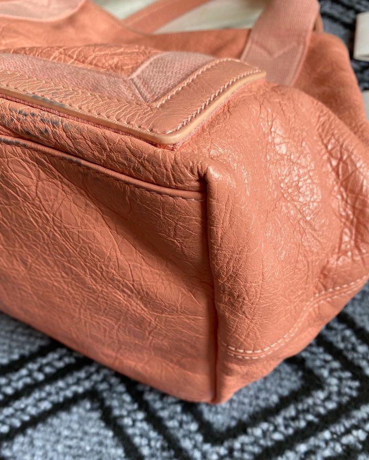Balenciaga bag (Category: Luxury Bags & Wallets) located in Quezon City. Submitted by luxury.xy (Listing ID 1149922139, Image 2). Description: 100% authentic Balenciaga hand bag Comes with dust bag and cards Color is soft peach made of soft and durable leather Barely used but please note color transfer/stain the the bottom Note minor rubs on corners and dirt No tears/rips See photos for details Selling low! MOP: BDO/BPI/Paypal/Gcash Sf c/o buyer 