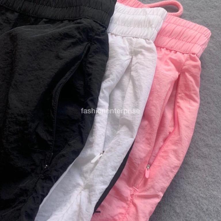 Nike vaporwave joggers with large swoosh in pink store