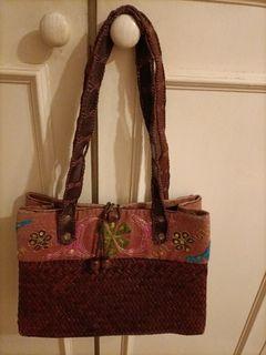 A well used straw bag.