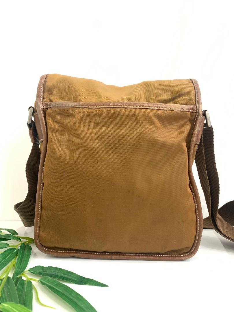 Prada bag - Authentic Prada Tobacco nylon sling/shoulder bag (Category: Bags & Wallets) located in Canberra. Submitted by radzzaq (Listing ID 1150747315, Image 3). Description: It feature durable nylon with a long adjustable strap. The nylon remains clean but has some rubbing,sport and light signt of use. The leather trim has rubbing and wear to the piping and edge of the flap. the interior lining is clean. Dimensions L:7"(19cm)x W: 3"(7.5cm) x H