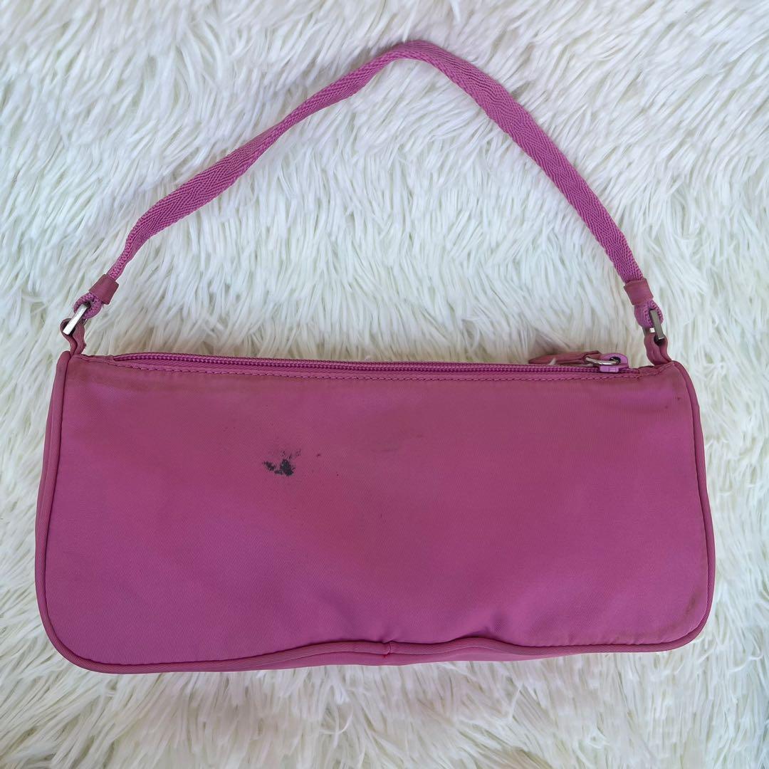 Prada Baguette Bag (Category: Luxury Bags & Wallets) located in Las Pinas. Submitted by Le.Pattie.Luxe (Listing ID 1151293186, Image 3). Description: Authentic Pink Prada Baguette Bag 💖Php 13k only💖 Inclusion: provided dustbag With small stain at the back Slight discoloration Approx. Dimensions: 9.5 x 4.5 x 2.5in (LxHxW) Can be worn shoulder bag/hand bag.