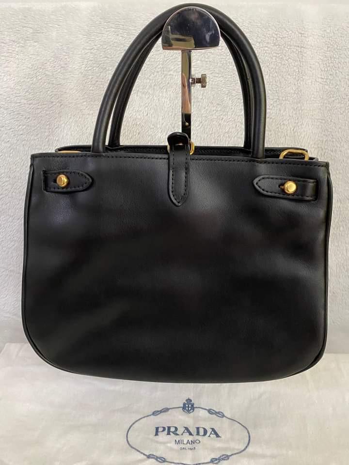 Prada Saffiano Cuir Gold Ring 2 way bag (Category: Luxury Bags & Wallets) located in Manila. Submitted by bagislifeshop (Listing ID 1146984361, Image 2). Description: ▪️Prada Saffiano Cuir Gold ring 2 way bag▪️ ✔️In transit to Manila ✅Model number: 1BA074 ✅Color: black in GHW ✅Material: saffiano cuir and calf leather ✅Condition: 9/10 ✅Measurements: L9” H7.5” W4.5” ✅Inclusions: dust bag, authenticity card, long strap and booklet..