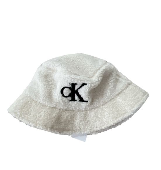 Calvin Klein furry bucket hat white logo, Women's Fashion, Watches &  Accessories, Hats & Beanies on Carousell