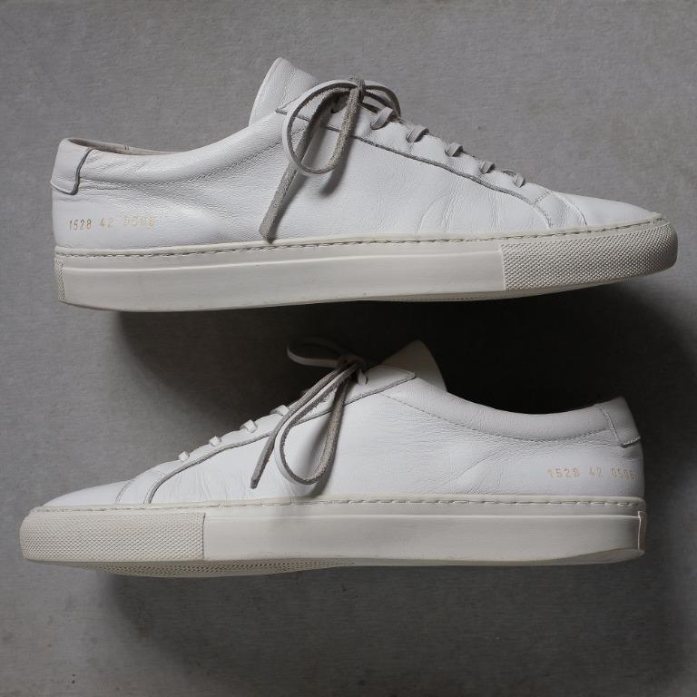Common Projects Achilles Low in White Leather Sneakers (Category: Sneakers) located in Cabuyao City. Submitted by jeremybooz (Listing ID 1147755352, Image 3). Description: Condition ✅ ✅ ✅ ☑ ☑ - Good Condition (Bought in Japan) Size: Men's EU 42 / US 9 / UK 8 / 27CM Visible heel drag. Some light scratches/stains on the leather due to normal usage. Cleaned and conditioned regularly. Intact stitching. Leather lace. Comes with the original lace..