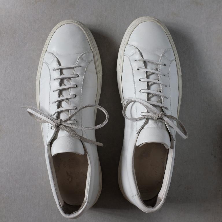 Common Projects Achilles Low in White Leather Sneakers (Category: Sneakers) located in Cabuyao City. Submitted by jeremybooz (Listing ID 1147755352, Image 2). Description: Condition ✅ ✅ ✅ ☑ ☑ - Good Condition (Bought in Japan) Size: Men's EU 42 / US 9 / UK 8 / 27CM Visible heel drag. Some light scratches/stains on the leather due to normal usage. Cleaned and conditioned regularly. Intact stitching. Leather lace. Comes with the original lace..