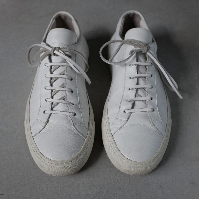 Common Projects Achilles Low in White Leather Sneakers (Category: Sneakers) located in Cabuyao City. Submitted by jeremybooz (Listing ID 1147755352, Image 1). Description: Condition ✅ ✅ ✅ ☑ ☑ - Good Condition (Bought in Japan) Size: Men's EU 42 / US 9 / UK 8 / 27CM Visible heel drag. Some light scratches/stains on the leather due to normal usage. Cleaned and conditioned regularly. Intact stitching. Leather lace. Comes with the original lace..